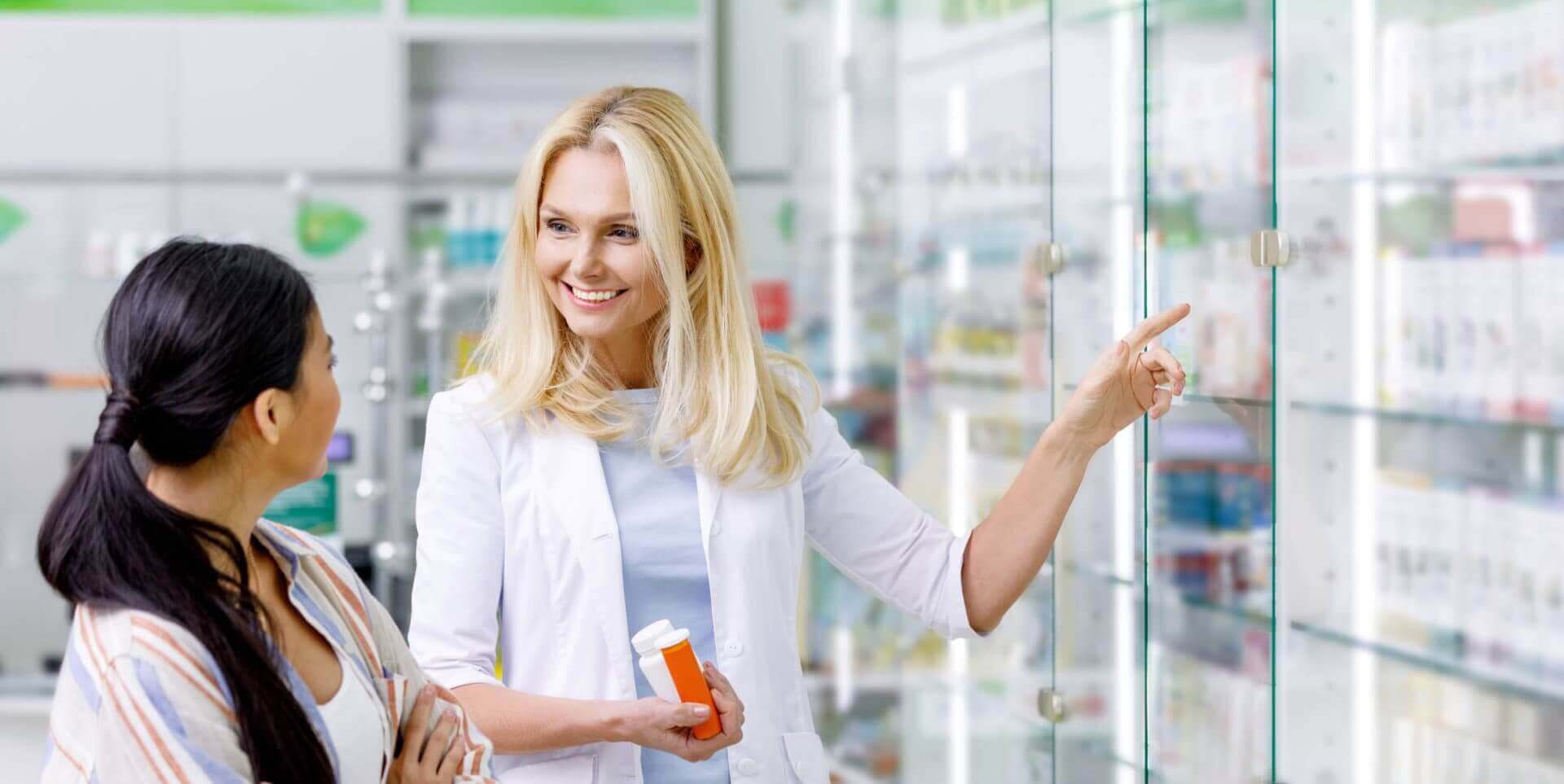 pharmacist holding medicines helping customer
